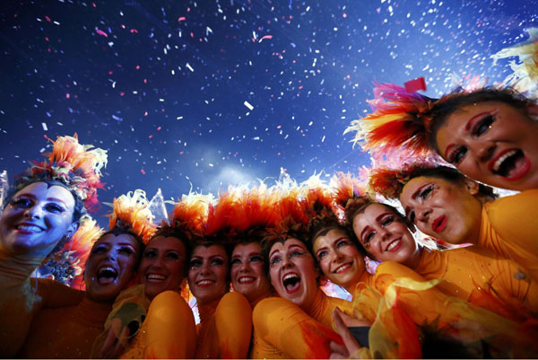Performers pose after the end of closing ceremony of the London 2012 Olympic Games at the Olympic stadium August 12, 2012. Games over, time to party