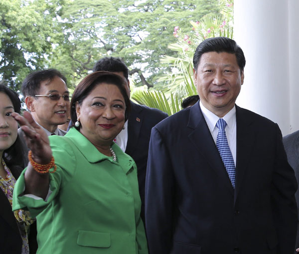 President Xi Jinping (R) is welcomed by Prime Minister of Trinidad and Tobago Kamla Persad-Bissessar before their talks in Port of Spain, Trinidad and Tobago, June 1, 2013. Xi vows to advance ties with Trinidad and Tobago