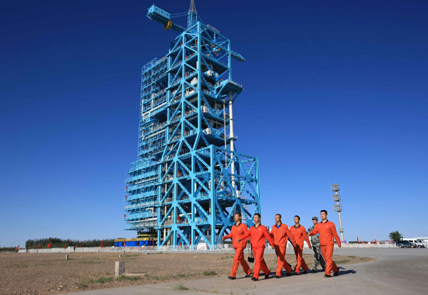 Staff workers march to inject fuel into the Long March-2FT1 carrier rocket at the Jiuquan Satellite Launch Center in Northwest China's Gansu province, Sept 28, 2011. One small step for Tiangong-1