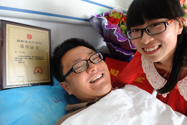 Zhang Hui, accompanied by his newly-wed wife, donates hematopoietic stem cells in a hospital bed at the Shandong Provincial Hospital in Jinan, the capital of East China's Shangdong province, on May 15, 2013. Newly-weds delay honeymoon for stem cells donation