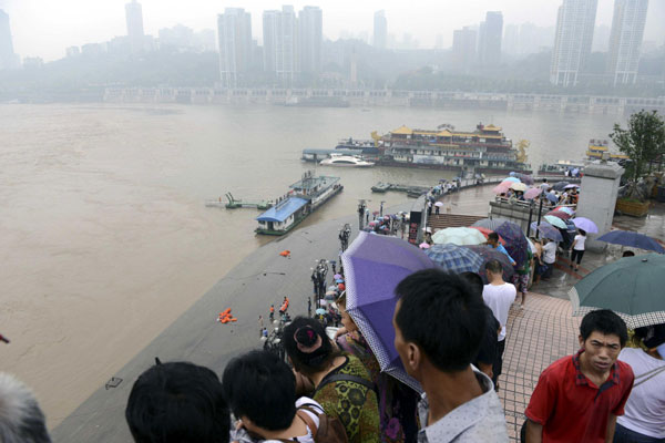 Photo take on July 1, 2013 shows the site where a barge capsized in southwest China's Chongqing Municipality. The barge capsized around 11 a.m. Monday after a cable that secured the vessel was broken by strong floodwaters. Eighteen people who were on board the ship fell into the water during the incident. Five people including one child went missing. 5 missing after floodwaters sink barge in SW China