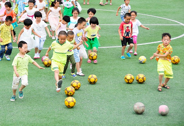 Kicking the ball: Kindergarten children play soccer