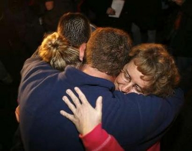 Family members celebrate after hearing that 12 miners were found alive in Sago, West Virginia, January 3, 2006.