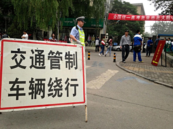 A traffic control sign is placed near an exam site in Beijing, June 7, 2013. The 2013 national entrance examination kicked off on Friday, with 9.12 million students. Big exam day kicks off