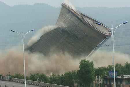 A cooling tower at the HunJiang Power Generation Company is imploded in Baishan,Northeast China's Jilin Province, July 6, 2007. China pledged to cut greenhouse gas emissions as it unveiled its first climate change action plan in early June. China has closed down small thermal power plants with total power generating capacity of 5.5 million kilowatts by now, completing 55 percent of the country's goal for this year, Xinhua reported.