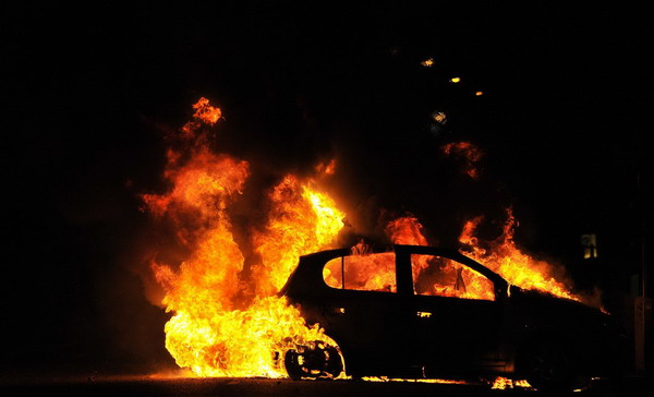 A car burns on a street in Ealing, London Aug 9, 2011. Matches called off as riots spread across London