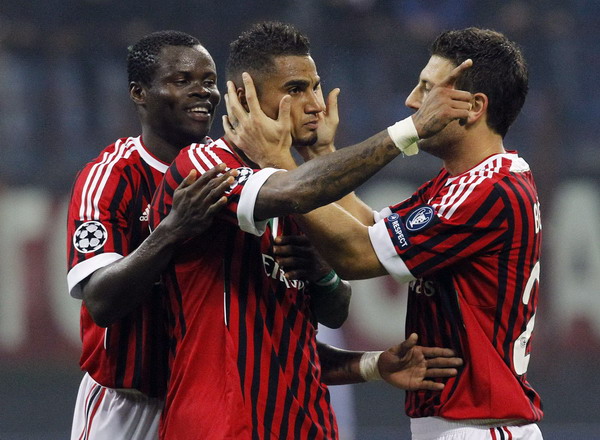 AC Milans's Kevin-Prince Boateng (C) celebrates with his teammates Taye Taiwo (L) and Daniele Bonera after scoring the second goal against BATE Borisov their Champions League soccer match at the San Siro stadium in Milan Oct 19, 2011. Erratic Milan stutter past Borisov