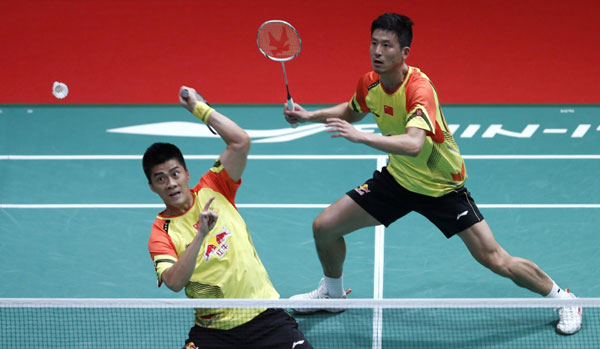 China's Fu Haifeng (L) with partner Cai Yun plays a shot during their men's doubles match against Indonesia's Saputro Rian Agung and Pratama Angga at the quarterfinals of the Sudirman Cup World Team Badminton Championships in Kuala Lumpur, May 23, 2013. China edges through Indonesia to for Sudirman semifinals