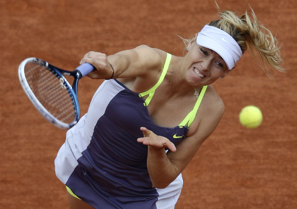 Maria Sharapova of Russia serves to Zheng Jie of China during their women's singles match at the French Open tennis tournament at the Roland Garros stadium in Paris June 1, 2013. Sharapova stretched by Zheng