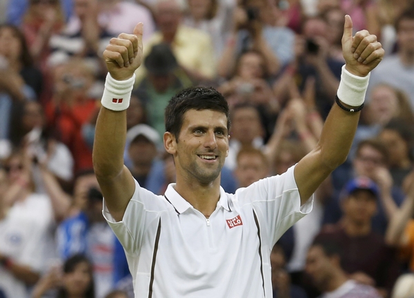 Novak Djokovic of Serbia celebrates after defeating Bobby Reynolds of the US during their men's singles tennis match at the Wimbledon Tennis Championships, in London June 27, 2013. World No 1 Djokovic sails to third round