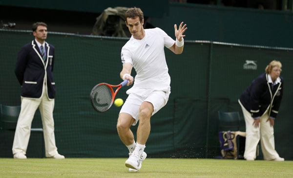 Andy Murray of Britain hits a return to Tommy Robredo of Spain in their men's singles tennis match at the Wimbledon Tennis Championships, in London June 28, 2013. World No 2 Murray cruises to last 16