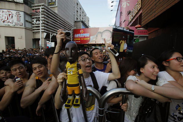 Fans react outside a sports store as Los Angeles Lakers NBA star Kobe Byrant pays a visit in the southern Chinese city of Shenzhen August 4, 2013. Kobe Byrant meets fans in Shenzhen