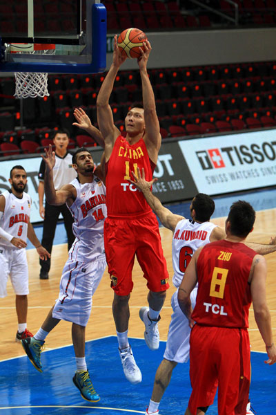 Yi Jianlian (11) of China jumps for a shot against Bahraini players at the 27th Asian Men's Basketball Championship in Manila, Philippines, Aug 7, 2013. Yi Jianlian storms back to help China crush Bahrain