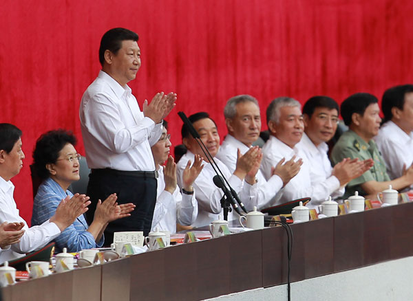 President Xi Jinping, 2nd left, who is also the general secretary of the Communist Party of China Central Committee and chairman of the Central Military Commission, declares the 12th National Games open at the Olympic Sports Center in Shenyang, Northeast China's Liaoning province, Aug 31, 2013. Games start is grand, without grandstanding