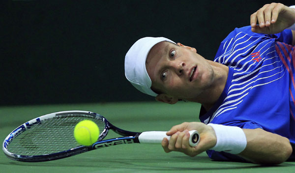 The Czech Republic's Tomas Berdych watches the ball as he falls during his Davis Cup semifinal against Argentina's Leonardo Mayer in Prague on Friday. Czechs take charge of Cup semifinal