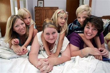From left, Dawn Warthen and her daughter Allyson Cross, Michelle Jorgenson and her daughter Cheyenne, and Jenafer Elin and her son Joshua hang out in a bedroom during their reunion Sunday, June 25, 2006 in Fresno, Calif. The mothers located one another starting a year ago through the Donor Sibling Registry, a Web site that enables mothers artificially inseminated by the same donor _ and children fathered by the same man _ to find each other. In this case, the women all used 3066, whose sperm was provided by the California Cryobank, based in Los Angeles. (AP