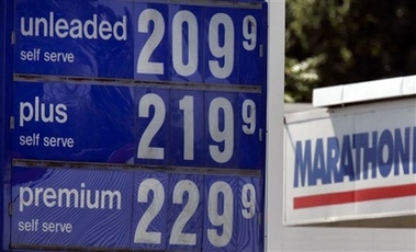 Gasoline prices are shown at a station in Indianapolis in this September file photo. A new study says Americans are burning nearly 1 billion more gallons of gasoline each year than they did in 1960 because of their expanding waistlines. (AP