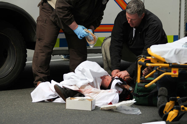 A victim is attended to at the scene of an explosion at the Boston Marathon in Boston, Massachusetts, April 15, 2013. Three dead in US marathon bomb