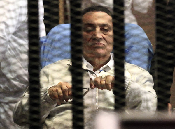 Egypt's ousted President Hosni Mubarak sits inside a dock at the police academy on the outskirts of Cairo, in this file picture taken April 15, 2013. Egypt's Mubarak may be freed